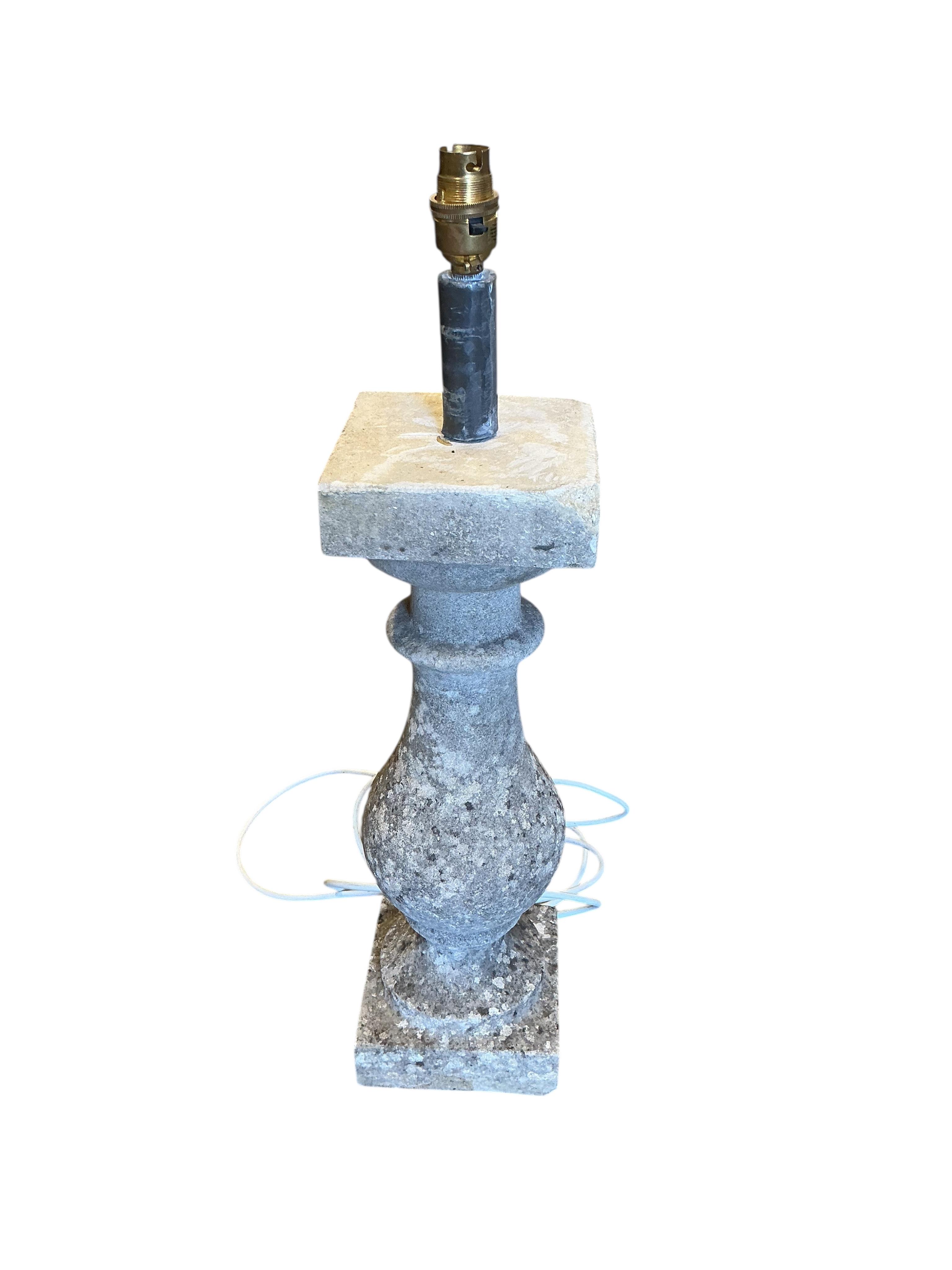 A reconstituted stone baluster table lamp, height including shade 73cm